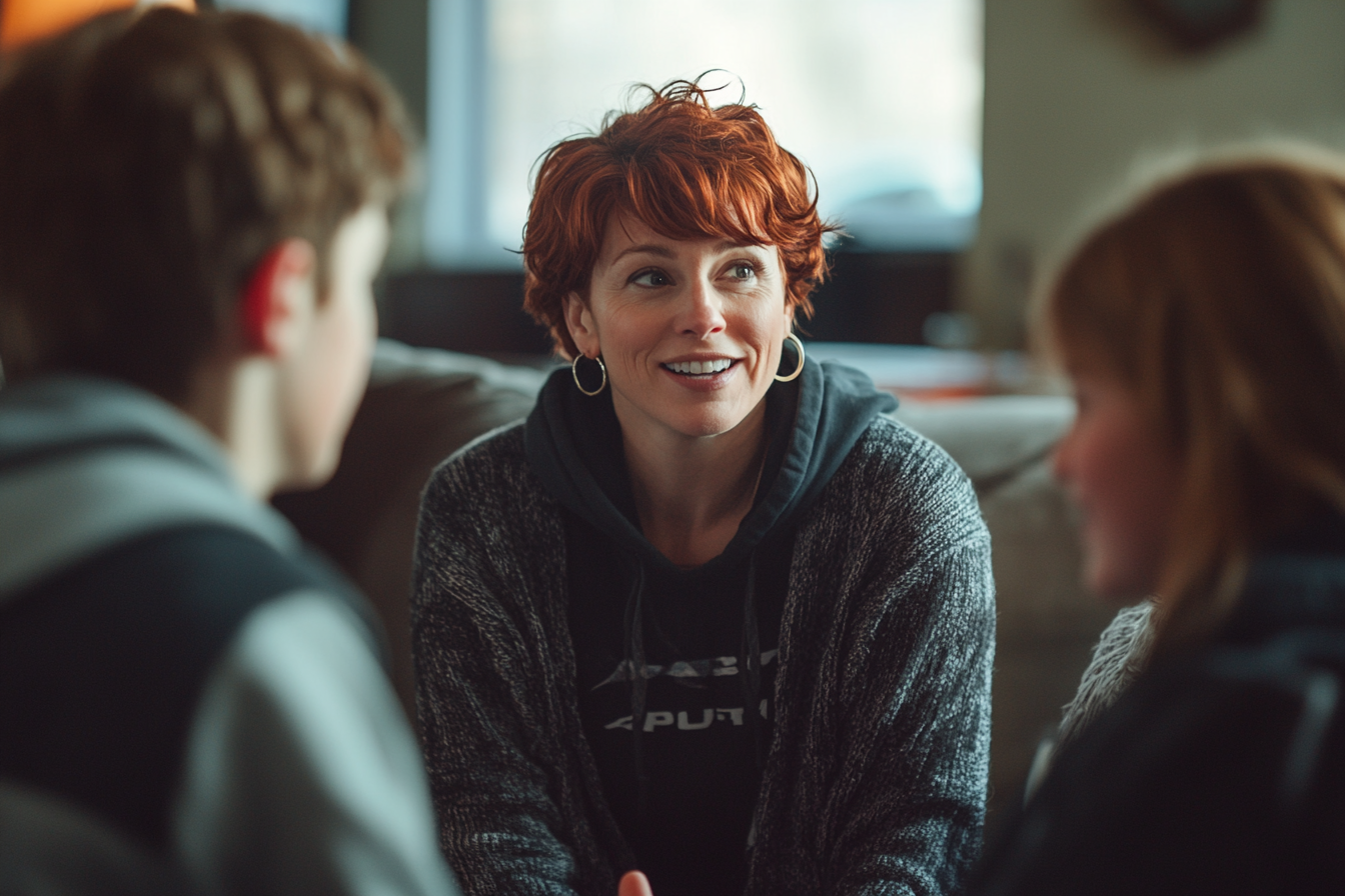 Woman in her thirties talking to her teenage children on a sofa | Source: Midjourney