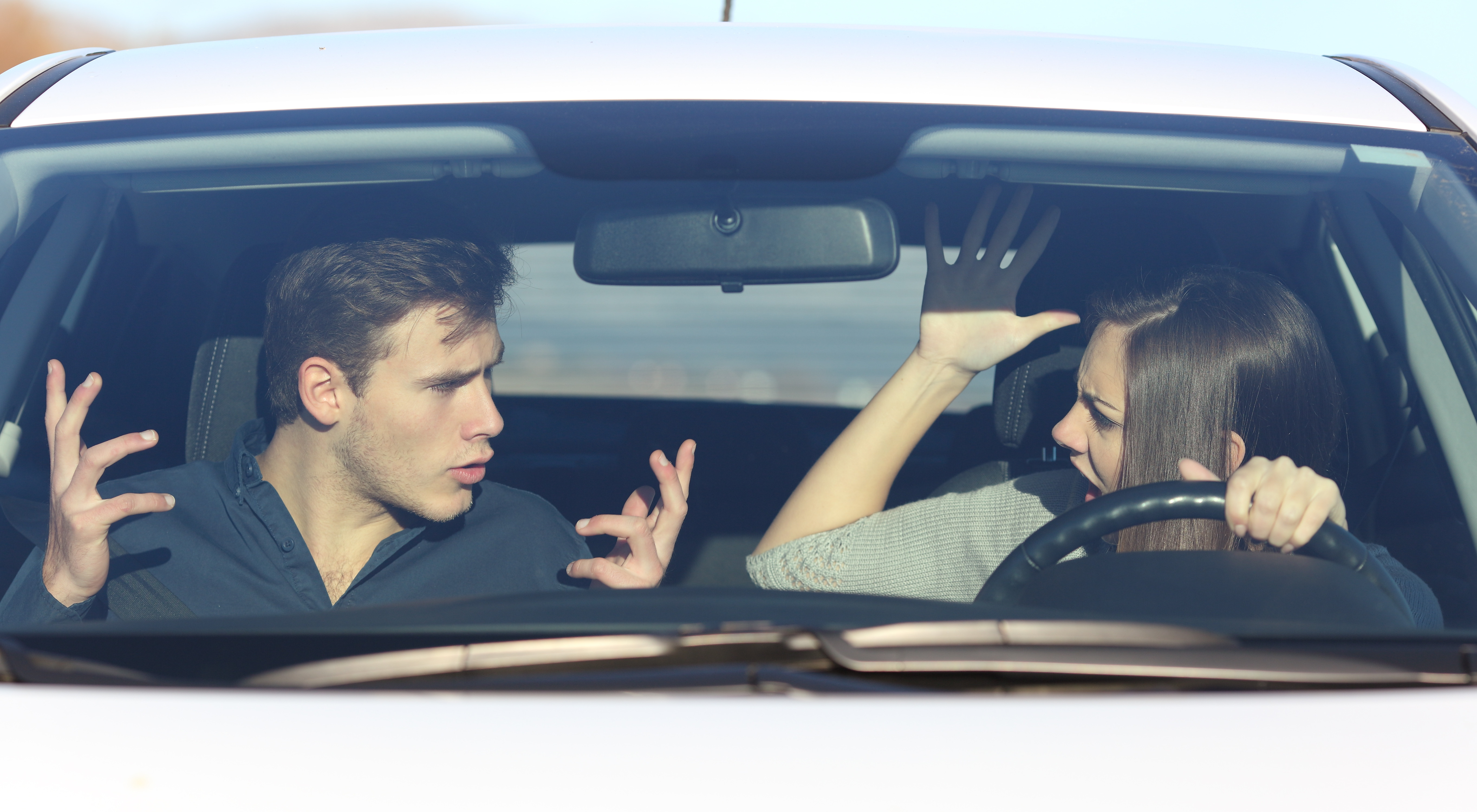Couple se disputant alors qu'elle conduit une voiture | Source : Getty Images