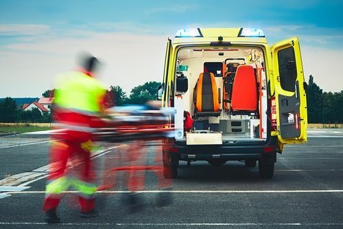Le secouriste tire la civière avec le patient jusqu'à l'ambulance. | Photo : Shutterstock