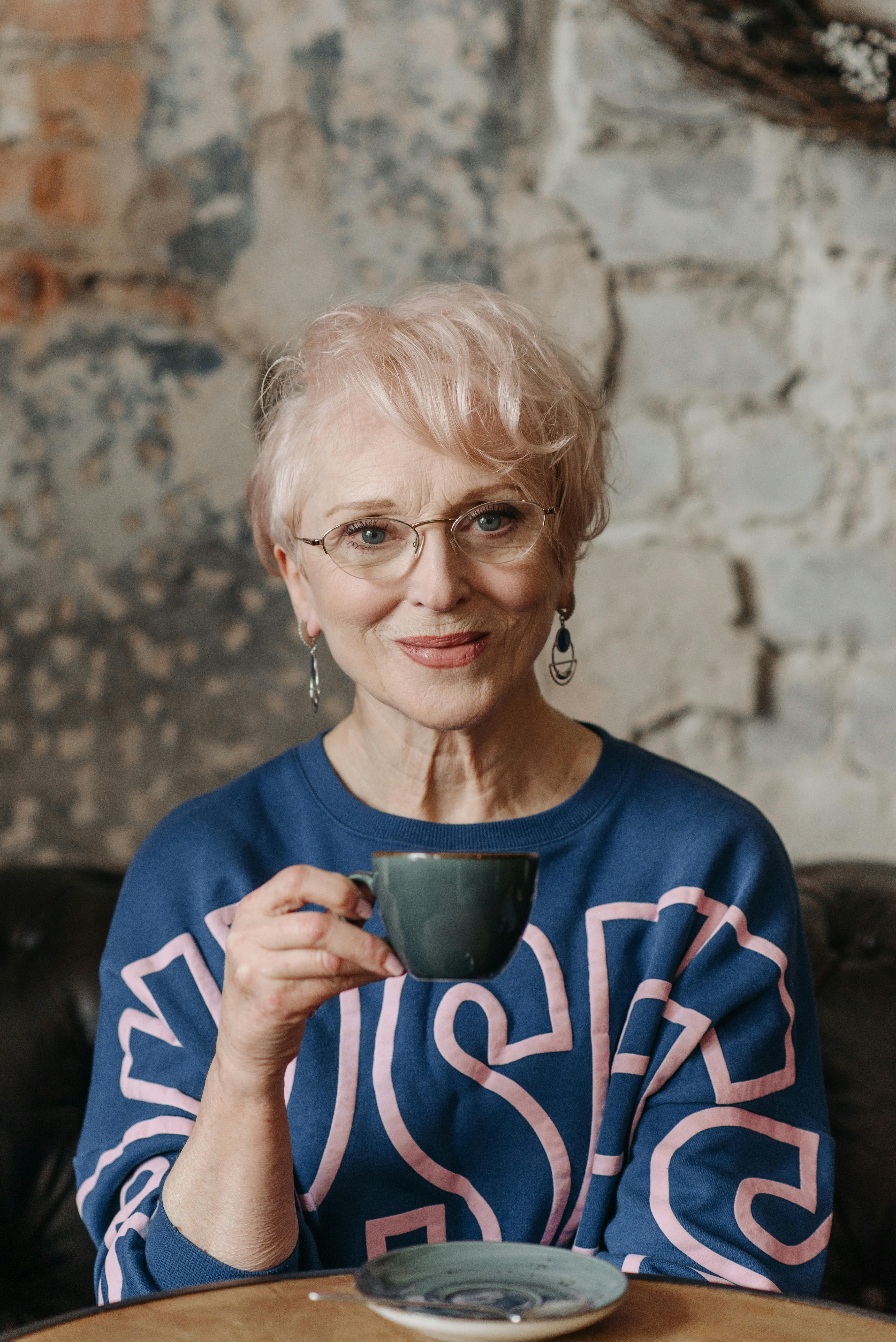 Une femme âgée souriante tenant une tasse | Source : Pexels