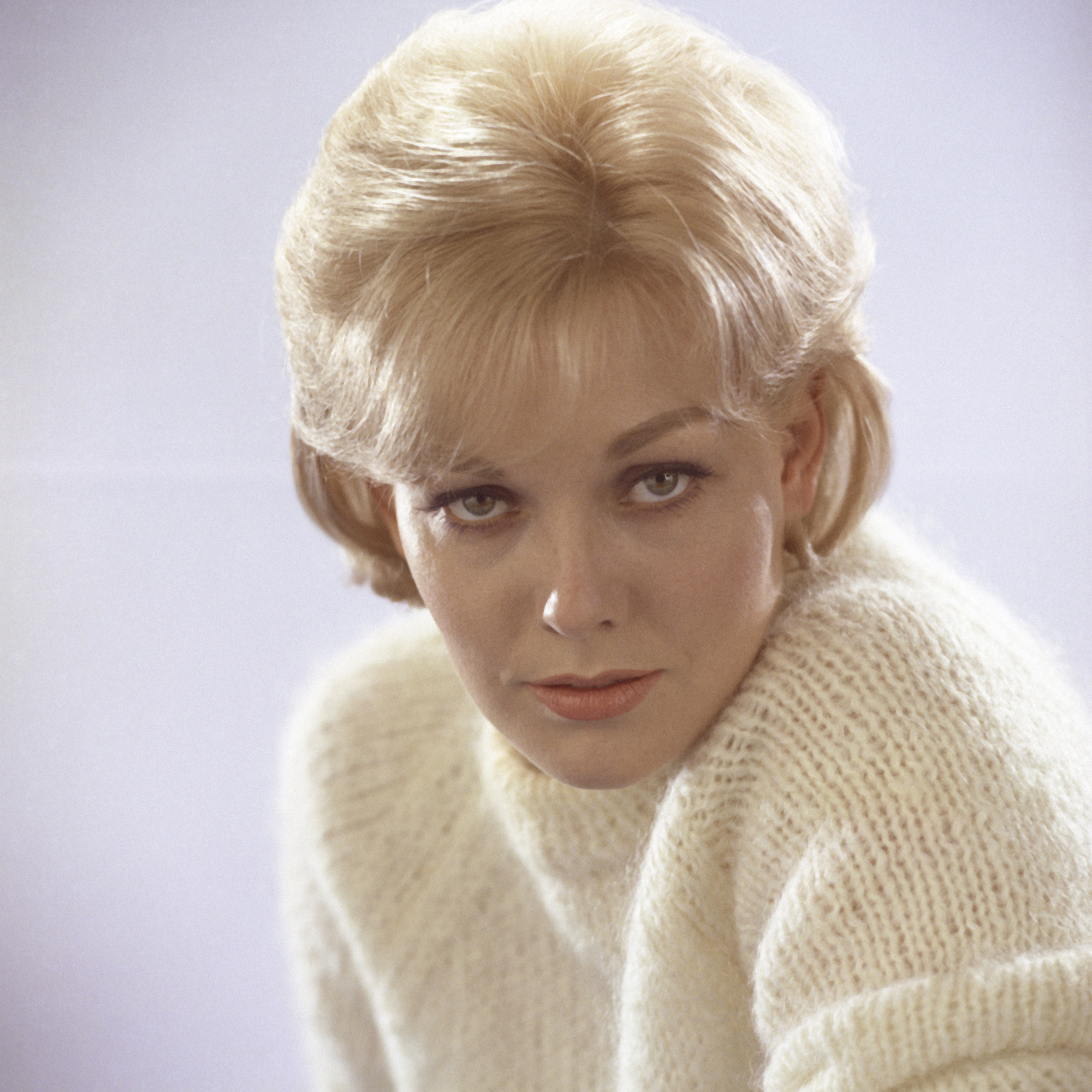 Portrait publicitaire de Kim Novak en studio, posant en chandail blanc, vers 1960. | Source : Getty Images