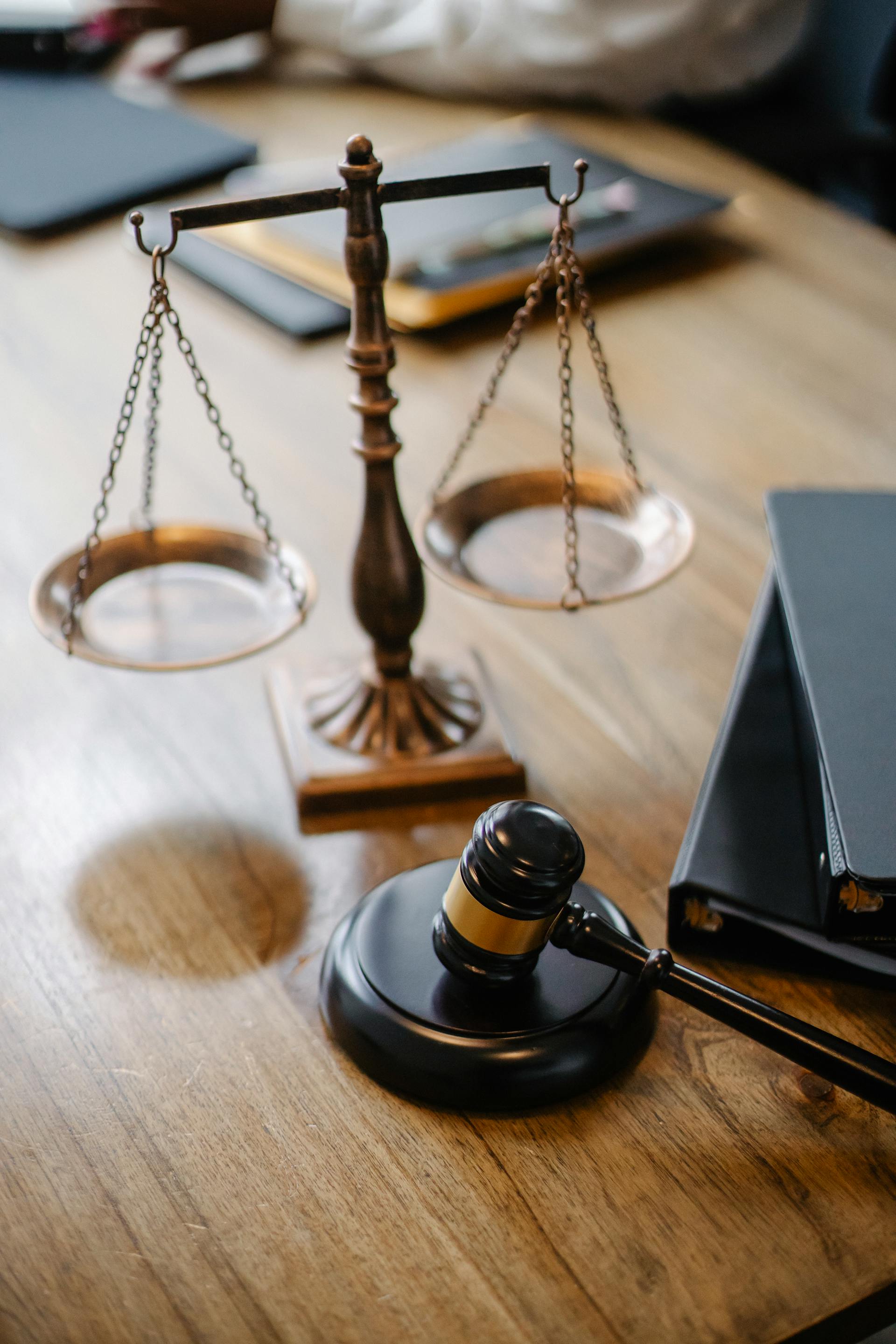 A desk with a gavel and scales in a courtroom | Source: Pexels